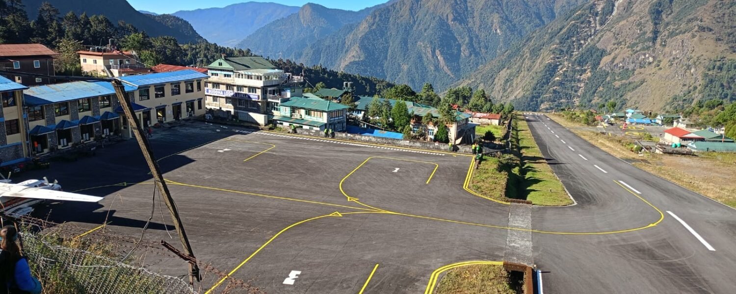 Trekkers waiting near aircraft at Tenzing-Hillary Airport during Lukla flight delays