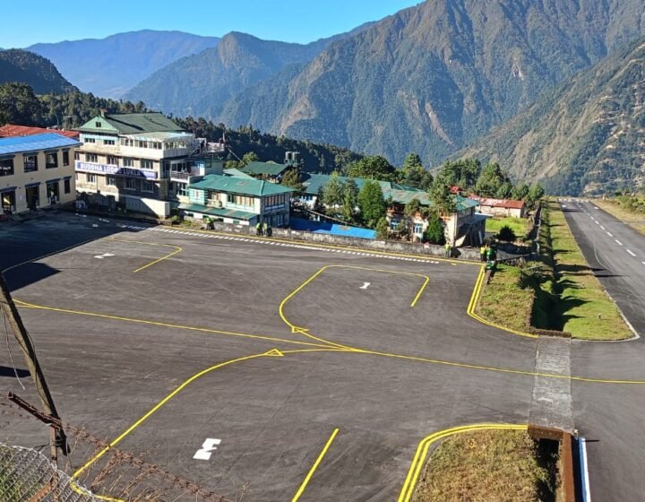 Trekkers waiting near aircraft at Tenzing-Hillary Airport during Lukla flight delays